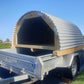Animal shelter for sale in NZ | suitable for large dogs, pigs, lambs and calves | Round wooden shelter with corrugate iron roof, floor boards and back wall waiting for delivery on a single axle trailer | For sale in Auckland, Waikato and the North Island New Zeland